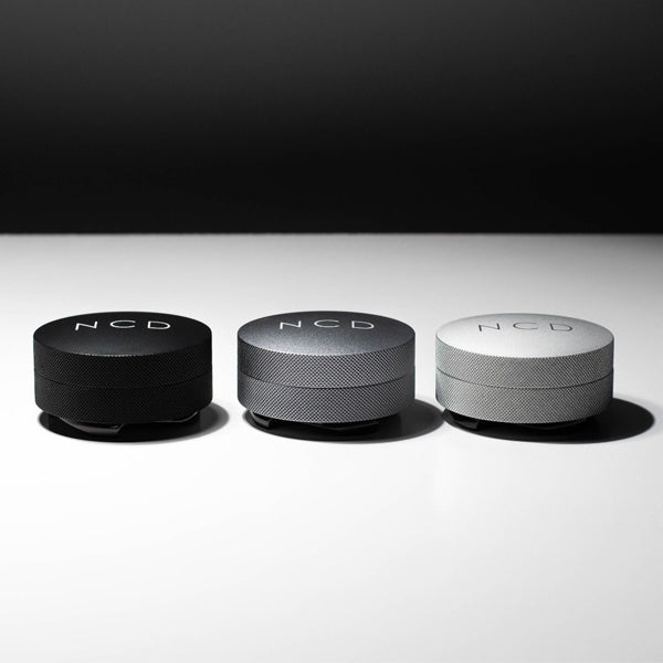 all three colours of Nucleus coffee distribution tools