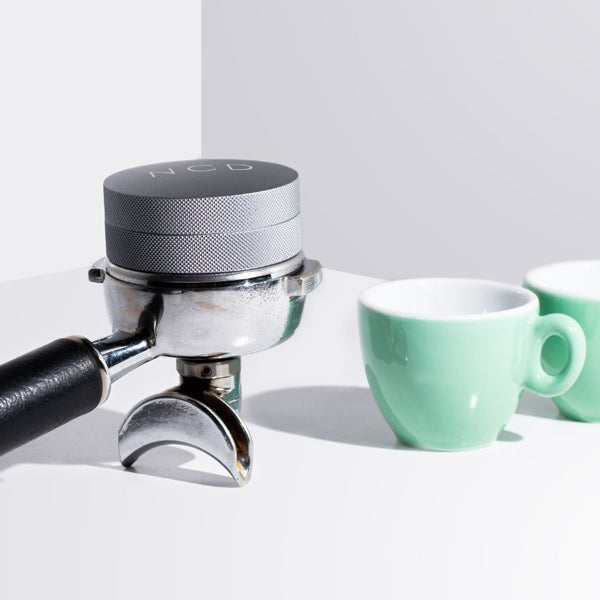 Nucleus coffee distribution tool  in a portafilter basket